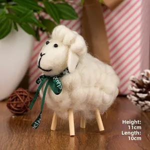 Detail of wool felt sheep ornament with green ribbon and natural wood legs, size 11x10cm