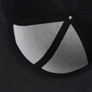 Macro detail of high-quality black baseball cap interior stitching and reinforced seam construction