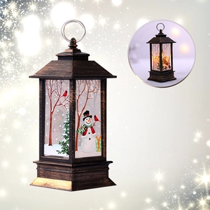 Detail of Christmas lantern with snowman scene and warm LED glowing inset effect