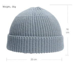 Flat lay of light blue knit beanie showing size 16x20cm and weight 35g specs