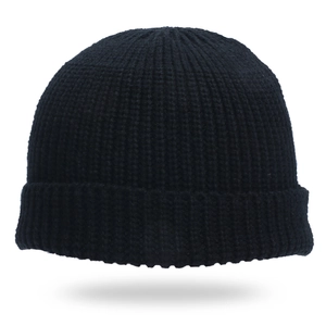 Close-up of black ribbed knit texture on a winter beanie hat with precise stitching