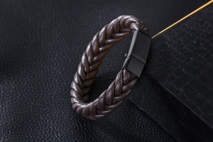 Gros plan détaillé du bracelet en cuir tressé marron foncé avec fermoir en acier noir
