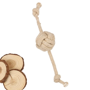 Durable cotton rope dog toy with ball knots for pet teething on natural wood base
