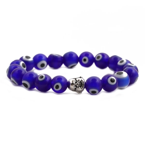 Macro detail of natural blue beads with evil eye pattern and silver buddha head charm