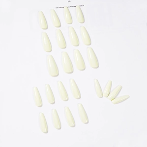 Glossy long coffin shape press-on nails in creamy yellow color, set of 24 pieces