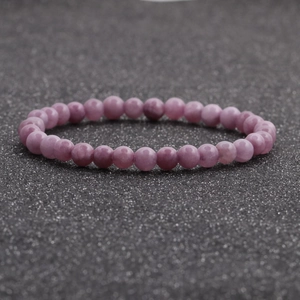 Detalle de cuentas de ágata morada de 6mm con textura natural en una pulsera de cuentas