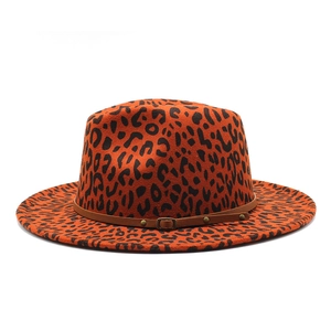 Detail of orange leopard print wool fedora hat featuring brown leather band and buckle