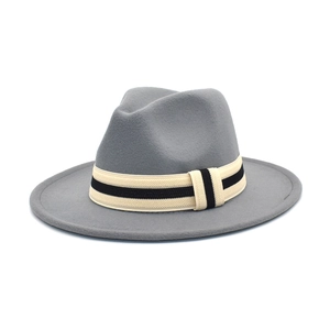 Detail of grey wool fedora hat featuring a black and white striped woven band