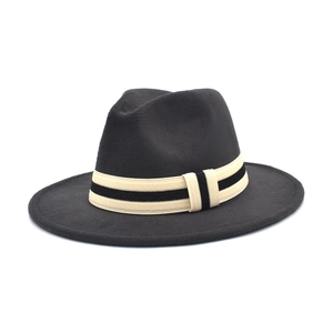 Detailed close-up of the black wool fedora featuring a striped ribbon and textured finish