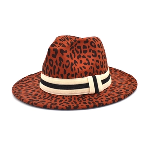 Detail of leopard print fedora hat featuring a black and white striped ribbon band