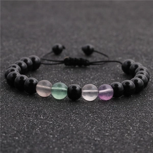 Handmade stone bead bracelet set with black obsidian and colorful crystals on dark background