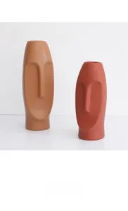 Macro view of matte Morandi ceramic face vase featuring 3D artistic relief details