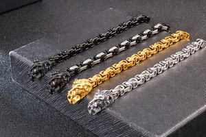 Detail of four Byzantine chains with lion head charms in gold, silver, black, and bicolor