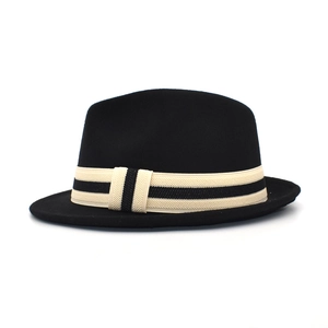 Detailed view of black wool fedora with a beige striped ribbon and classic crown