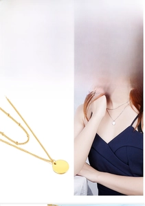 Detailed view of layered snake chain necklace with round beads and polished gold pendant