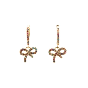 Close-up of gold bow earrings with colorful zircon micro-paving on a white background