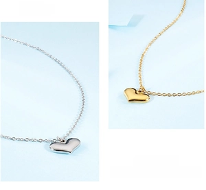 Detailed view of polished heart pendants in gold and silver on fine cross chains