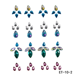 Flat lay of multiple colorful teardrop acrylic face jewels and body rhinestones sets