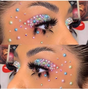 Detail of colorful acrylic rhinestones and pearls applied on eyes for 3D makeup look