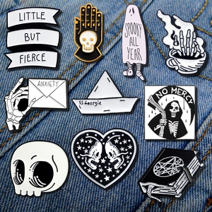 Gothic ghost and skeleton enamel pins set on blue denim fabric background for jackets