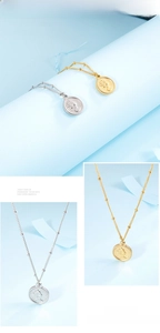 Detail of gold and silver Elizabeth coin pendant necklaces with rope edge on blue background