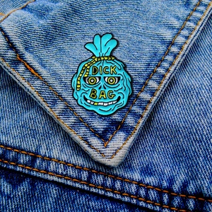 Funny blue enamel punk bag brooch with cartoon face and yellow rope on denim jacket