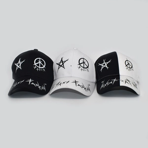 Detail view of cotton baseball caps with graffiti star patterns and adjustable straps