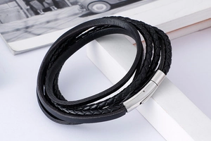 Close-up of black braided leather men's bracelet with silver magnetic stainless steel clasp