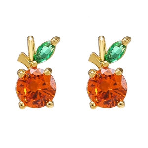 Detail of apple-shaped gold plated studs with orange zircon and green leaf gemstone