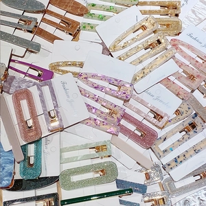 Detail of assorted geometric acrylic hair clips with tortoise and Morandi resin patterns