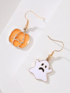 Detail of asymmetrical Halloween earrings featuring orange pumpkin and white ghost charms