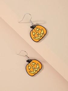 Detailed view of Halloween pumpkin dangle earrings with orange and yellow oil drip finish