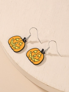 Macro detail of glossy orange Jack-o'-lantern pumpkin earrings with enamel-like finish