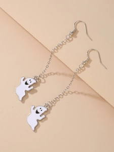 Macro detail of white enamel ghost earrings with silver metal chain for Halloween decor