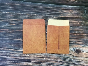 Detailed view of vintage brown kraft paper envelopes on a rustic wooden background