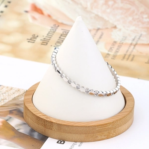 Macro shot of silver hexagon wave ring with micro-pave cubic zirconia on a ring stand