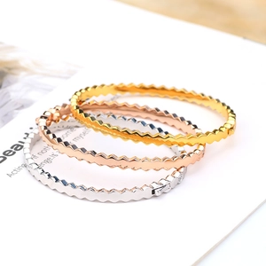 Close-up of hexagonal honeycomb bangles in gold rose gold and silver finishes