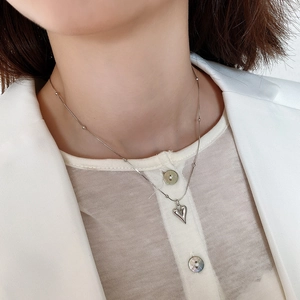 Elegant 925 sterling silver heart necklace with bead chain on model wearing white blazer