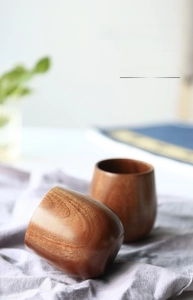 Detail of hand-carved wooden belly cups with dark red-brown grain in Japanese style