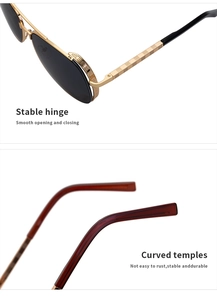 Detail of pilot sunglasses showing golden metal frame with engraved patterns and curved temples