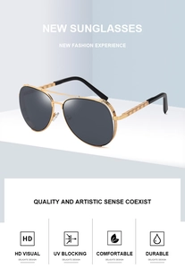 Detail of vintage aviator sunglasses with gold textured temples and dark lenses