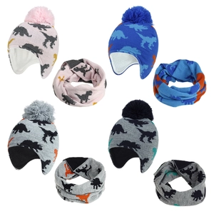 Detail of kids knit dinosaur hats and scarves set with warm fleece lining and pom-poms