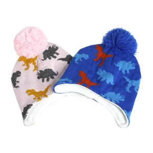 Detail of warm winter kids hat with cartoon dinosaur knit and soft fleece lining