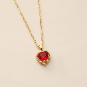 Gold twisted chain necklace with red zircon heart pendant surrounded by tiny clear crystals