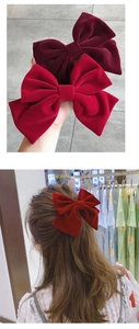 Detail of red velvet bow hair clip showing soft texture and elegant back-view styling