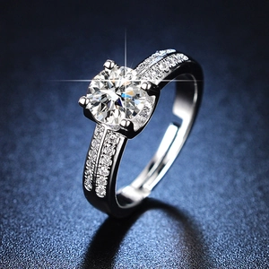 Macro shot of silver six-prong adjustable ring with a round brilliant moissanite stone