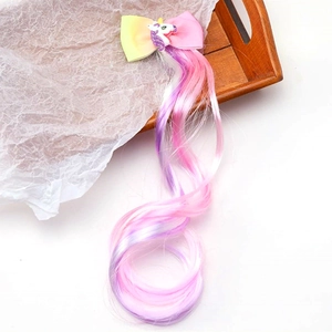 Detail of colorful gradient wig hair with a resin unicorn and ribbon bow hair clip