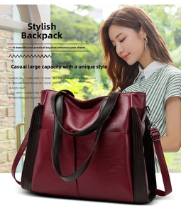 Detail view of burgundy leather tote bag showing large capacity and adjustable dual straps