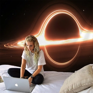 Detail view of the outer space black hole tapestry hung as a bedroom wall decoration