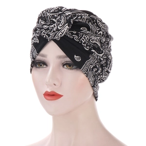 Black and white paisley pattern snail spiral turban hat for women on white background